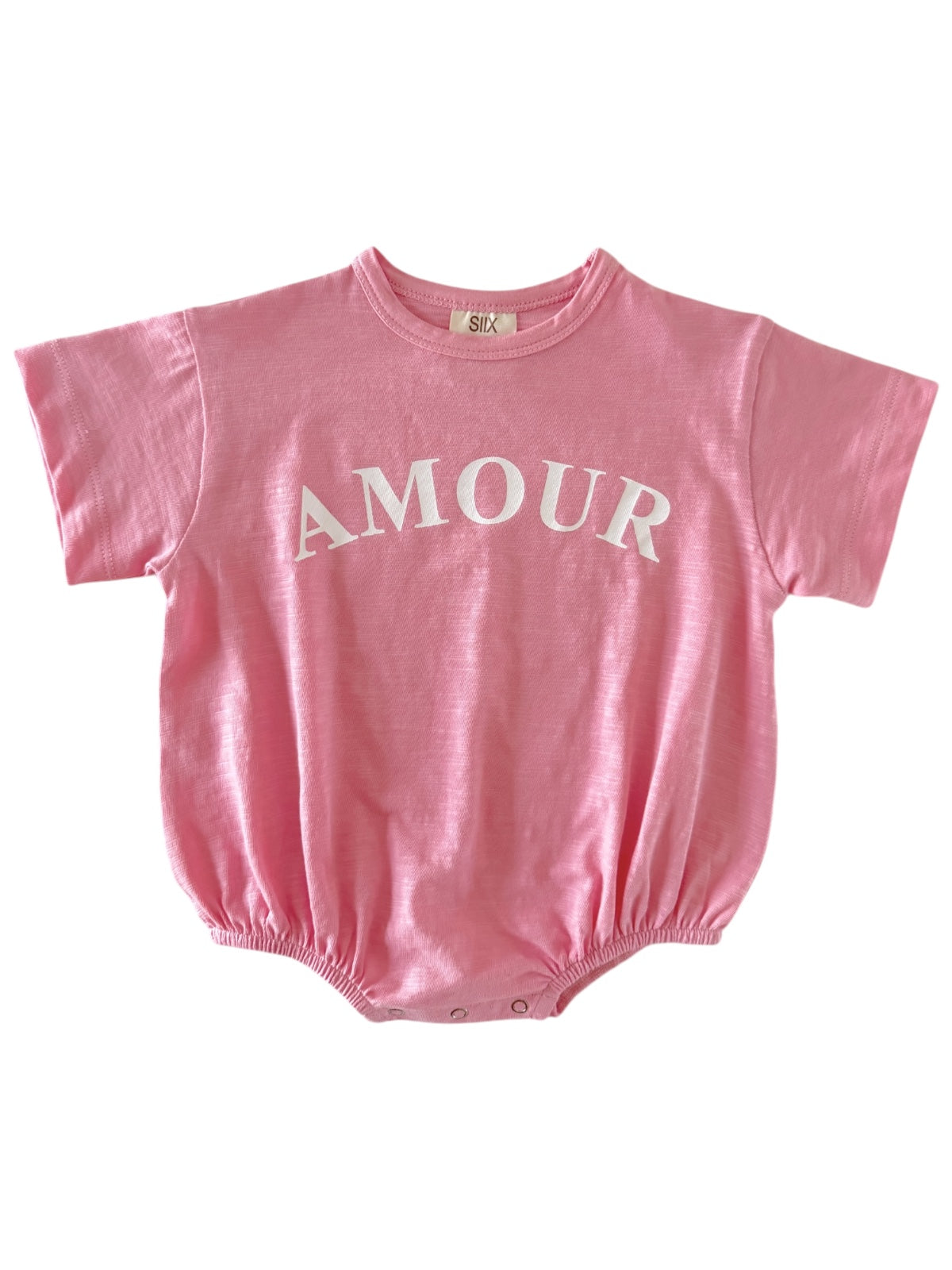 Pink baby onesie with "AMOUR" printed in white on the front. Elastic bottom for easy diaper changes.