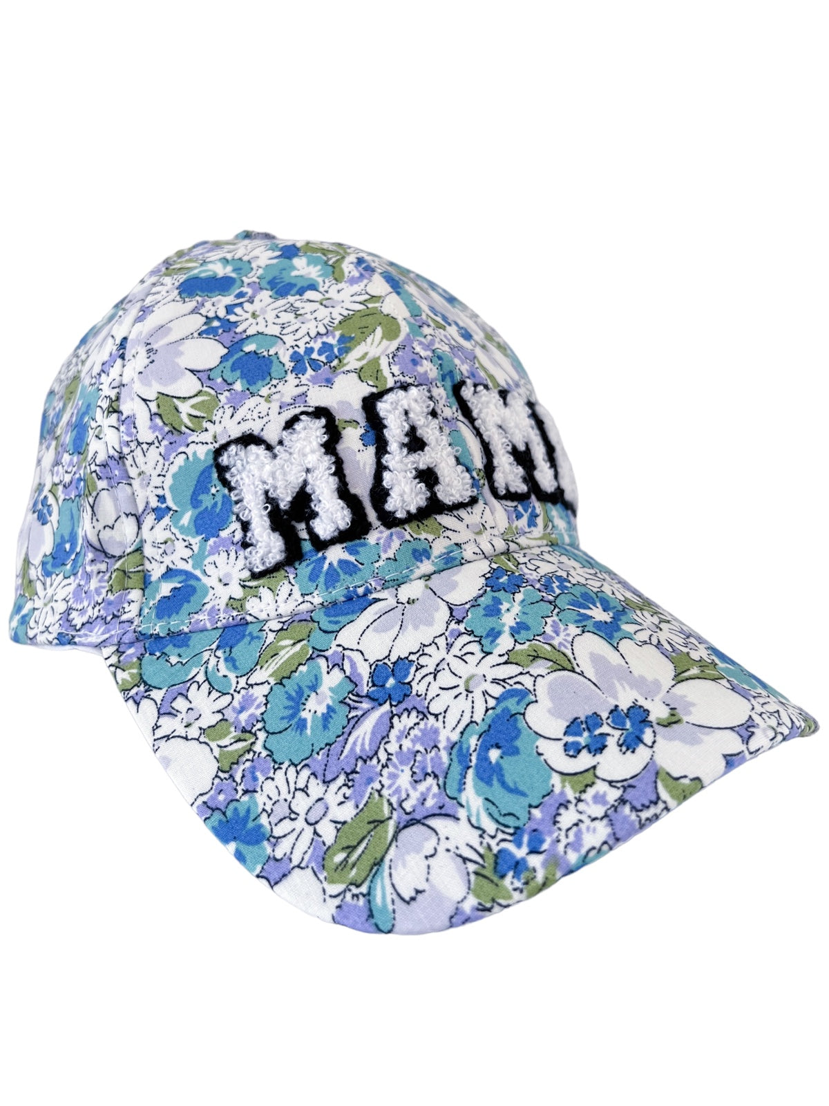 Floral-patterned cap featuring the word "MAMA" in textured white letters on the front.