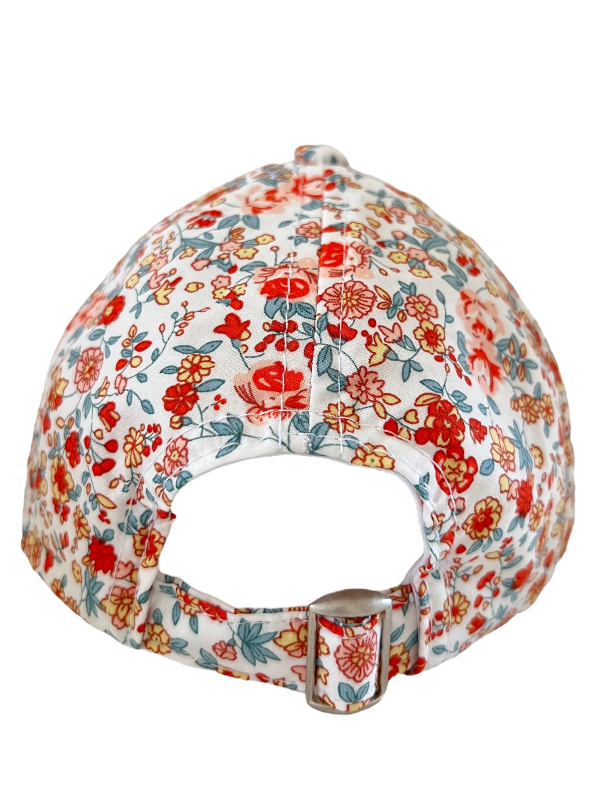 Floral-patterned cap viewed from the back, featuring a strap and metal buckle.