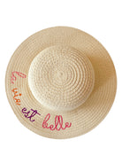 Wide-brimmed straw hat with the phrase "la vie est belle" embroidered in colorful letters.