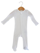 White baby onesie on a wooden hanger against a plain background. Ideal for infant sleepwear or lounging.
