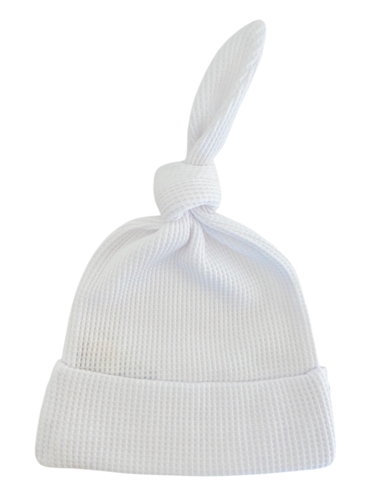 White cotton baby hat with a knotted top and a folded brim.