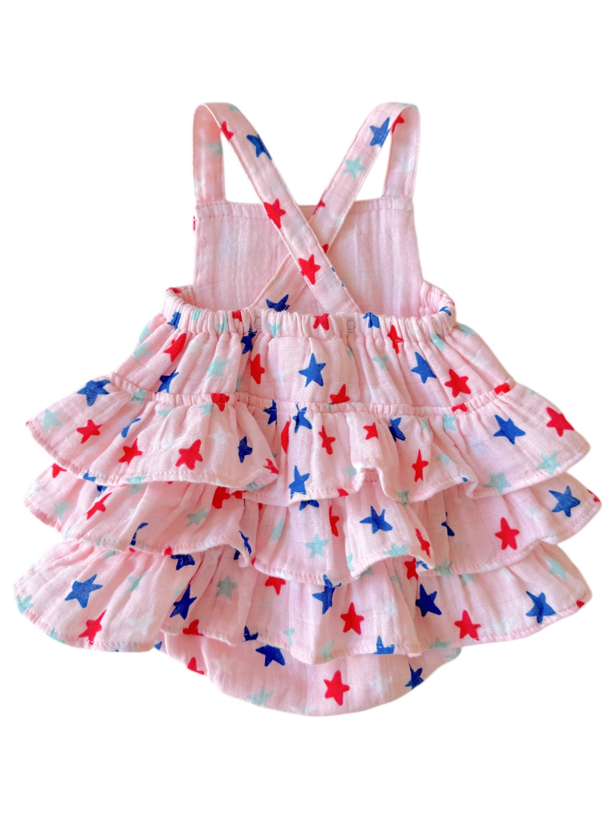 Pink dress with ruffled skirt, decorated with red, blue, and turquoise stars. Adjustable shoulder straps.