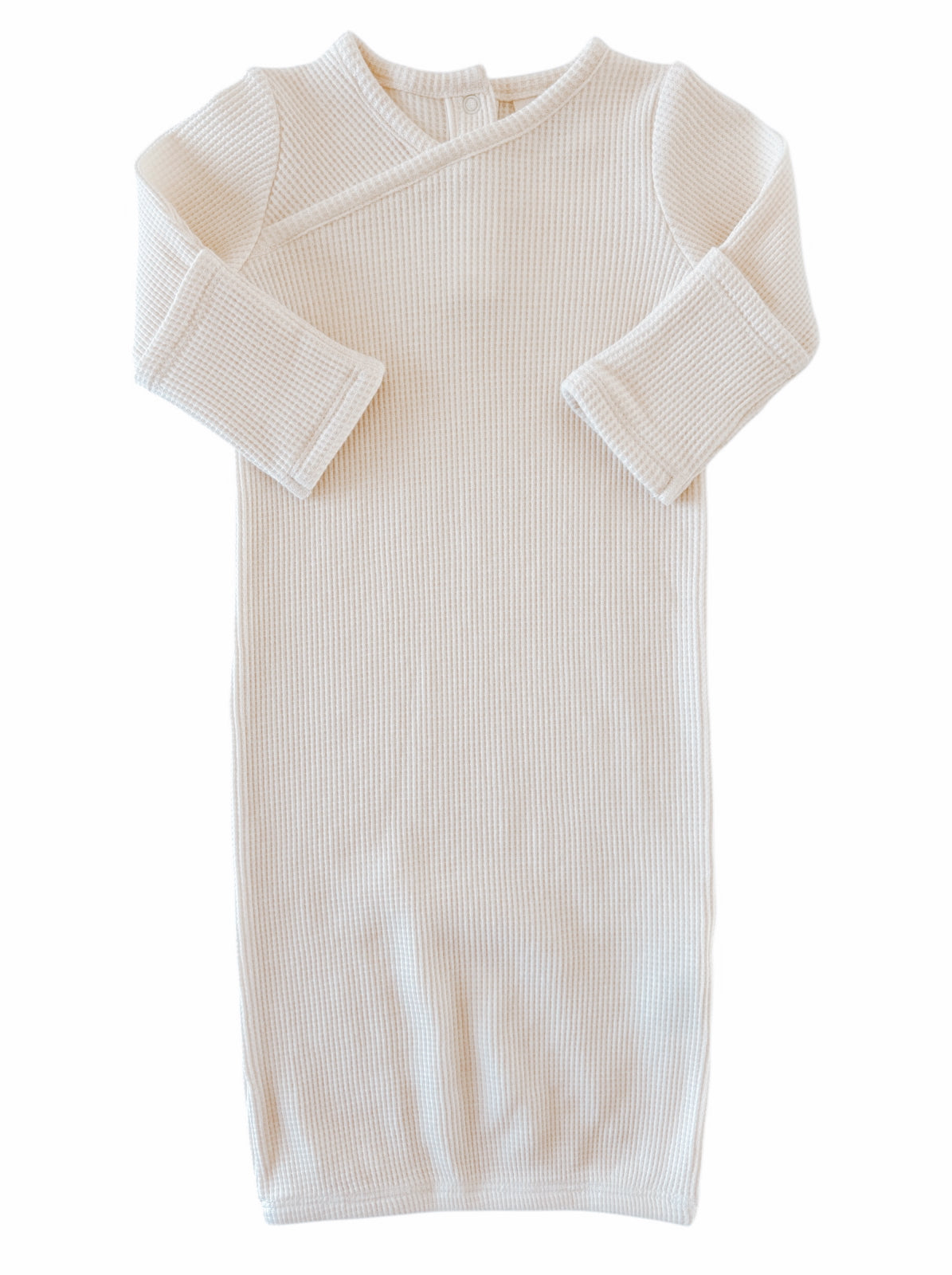 Cream-colored ribbed baby gown with long sleeves and a wrap design, perfect for infants.