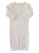Cream-colored ribbed baby gown with long sleeves and a wrap design, perfect for infants.