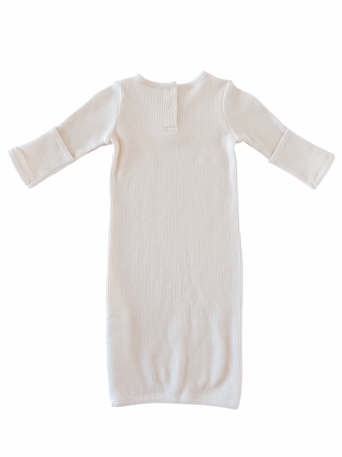 Cream ribbed long-sleeve dress displayed flat, showing back with button detail at the neckline.