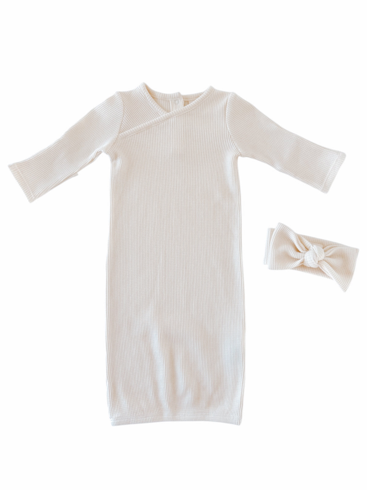 Cream-colored ribbed baby gown and matching headband, perfect for infants. Soft and stylish outfit for newborns.