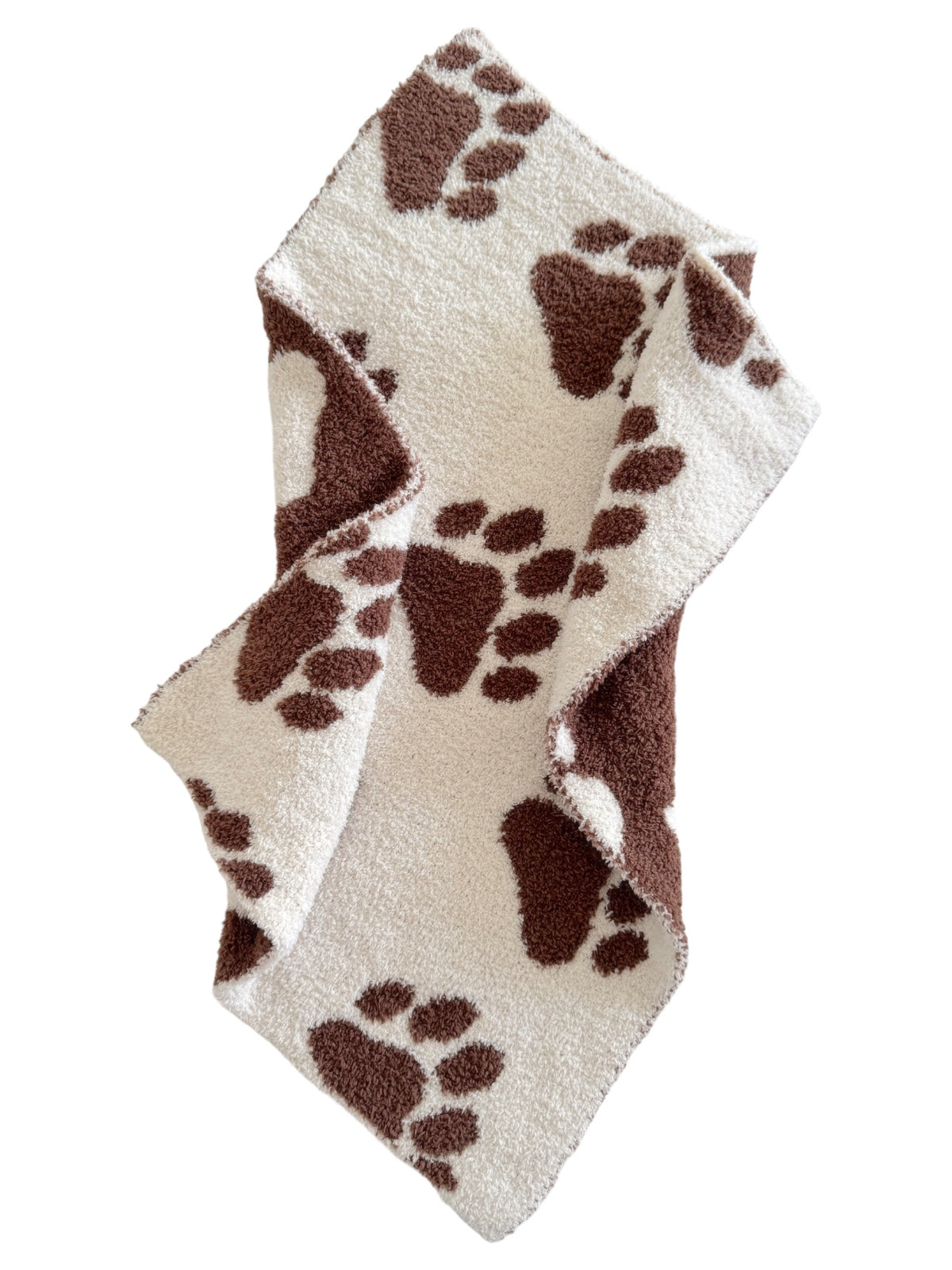 Soft fleece blanket with brown paw prints on a cream background, folded elegantly.