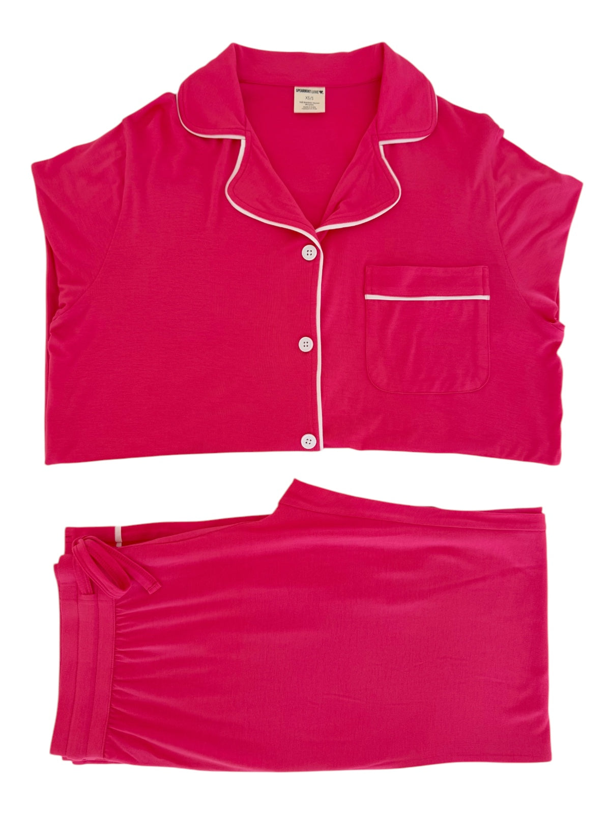 Bright pink women's pajama set featuring short sleeves, buttons, and a matching waistband.