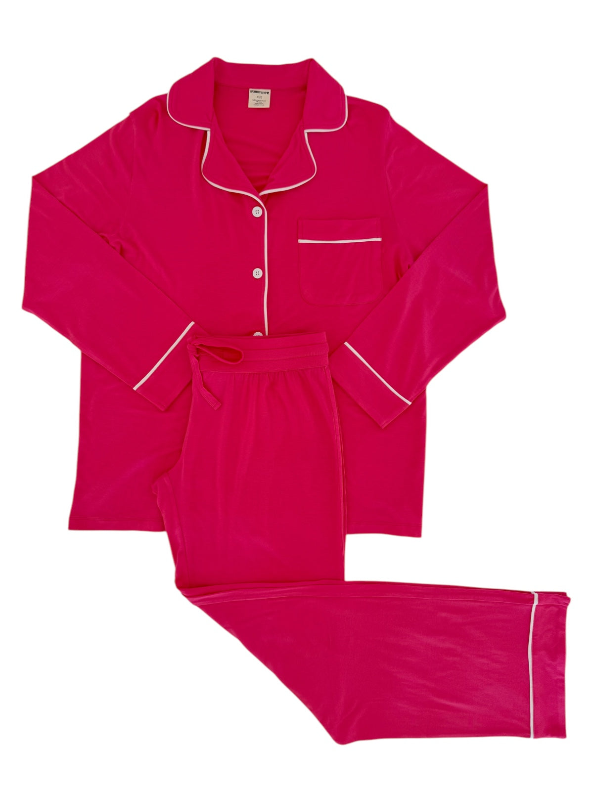 Bright pink pajama set featuring a button-up top with pocket and matching pants. Ideal for comfort and relaxation.