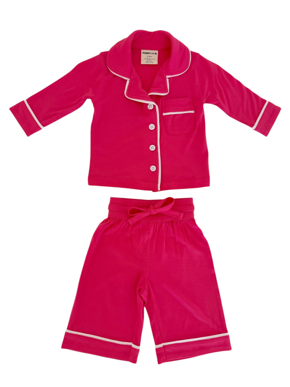 Bright pink children's pajama set with a collared top and elastic waist shorts featuring white accents.