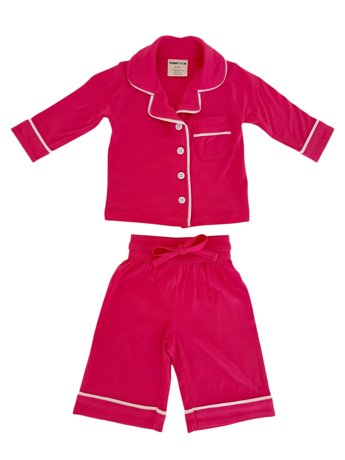 Bright pink children's pajama set with a collared top and elastic waist shorts featuring white accents.