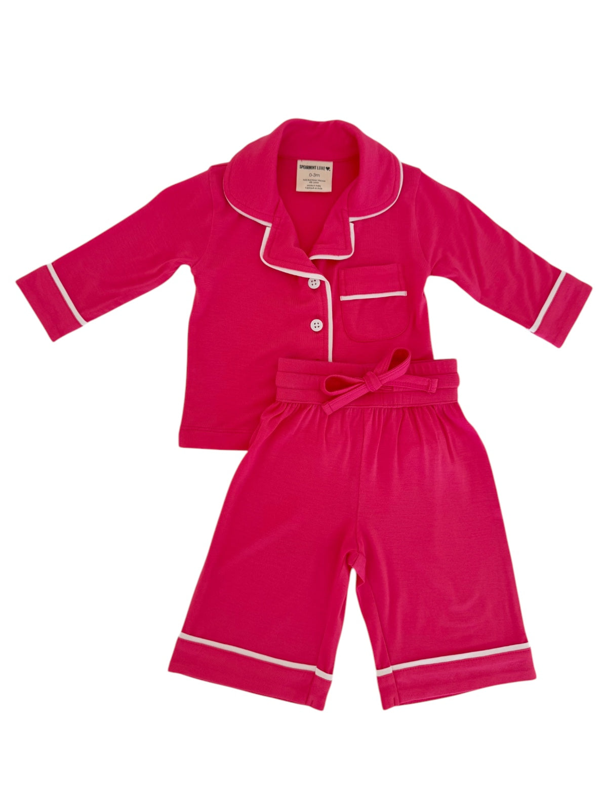 Bright pink kids' pajamas set featuring a button-up top and shorts with white trim. Perfect for cozy nights.