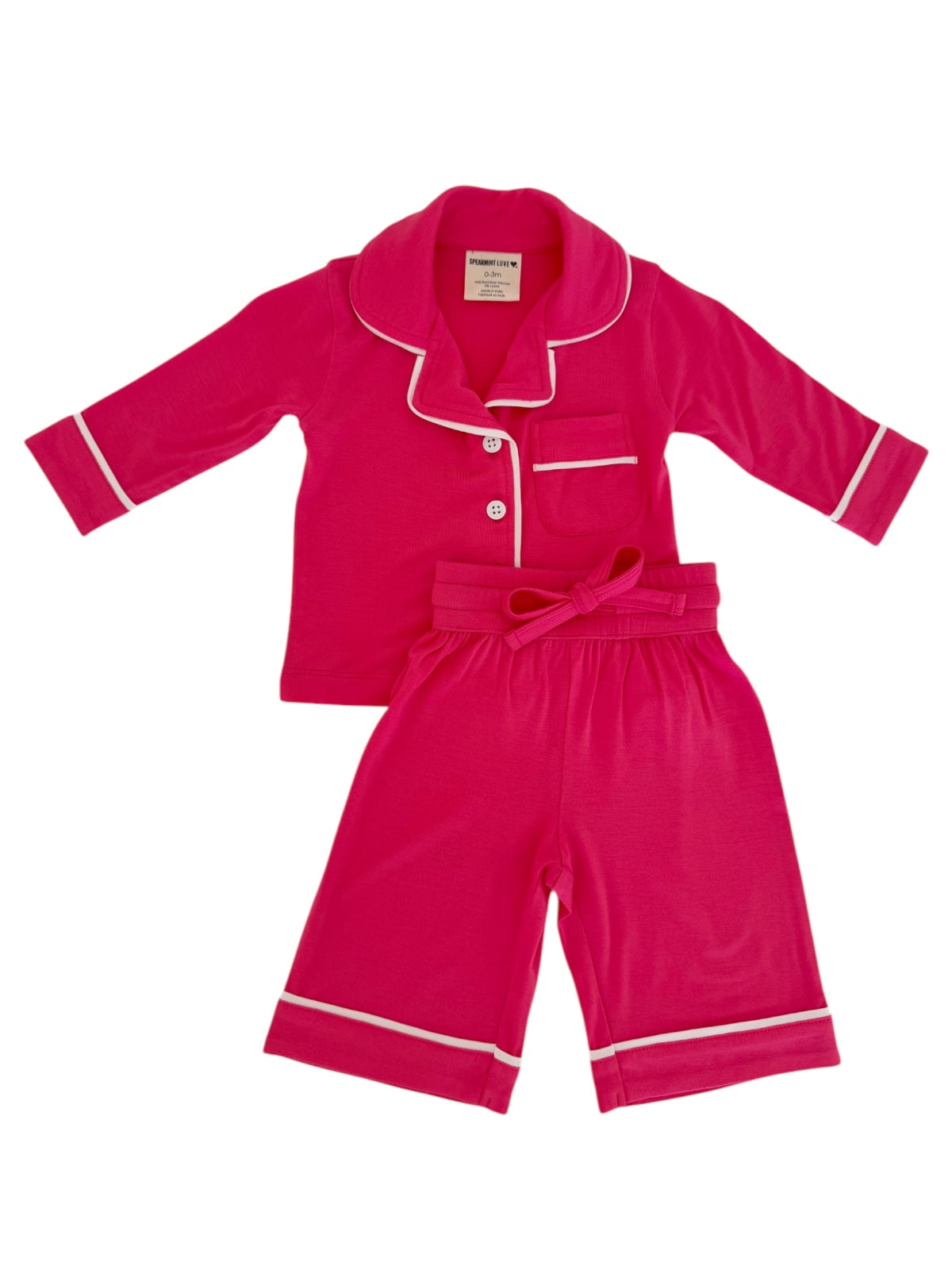Bright pink kids' pajamas set featuring a button-up top and shorts with white trim. Perfect for cozy nights.