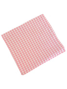 Pink gingham cloth napkin folded diagonally on a white background.