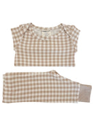 Tan and cream checkered infant pajamas, featuring a short-sleeve top and long pants, labeled size 0-3 months.