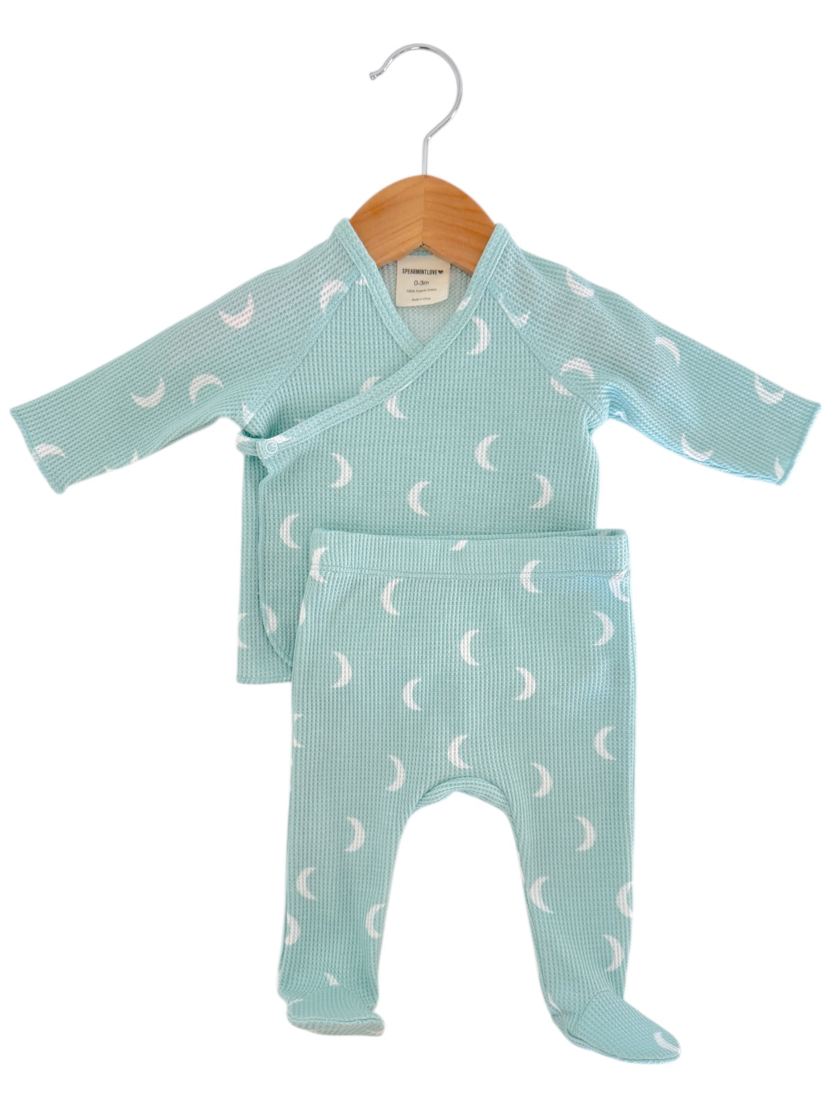 Light blue baby outfit with a wrap top and matching pants, featuring a subtle crescent moon pattern.