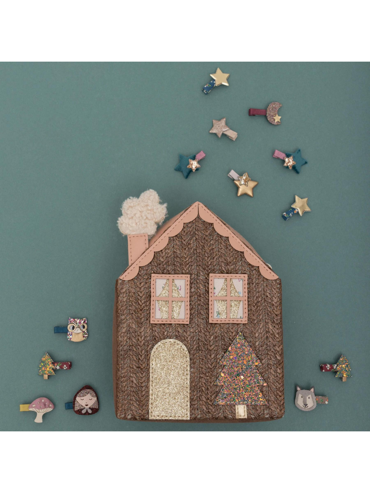 Colorful house-shaped accessory with decorative clips, stars, and animals against a teal background.