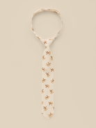 Beige tie with floral patterns on a light background, elegantly displayed for a stylish look.