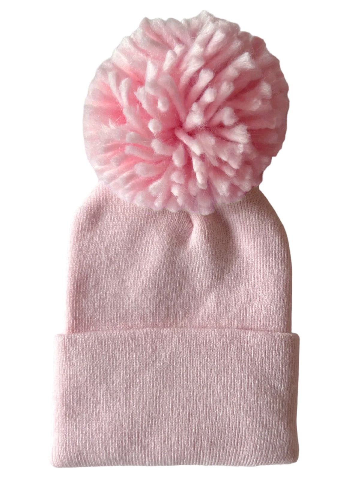 Pink knitted beanie hat with a large fluffy pom-pom on top, ideal for winter wear.