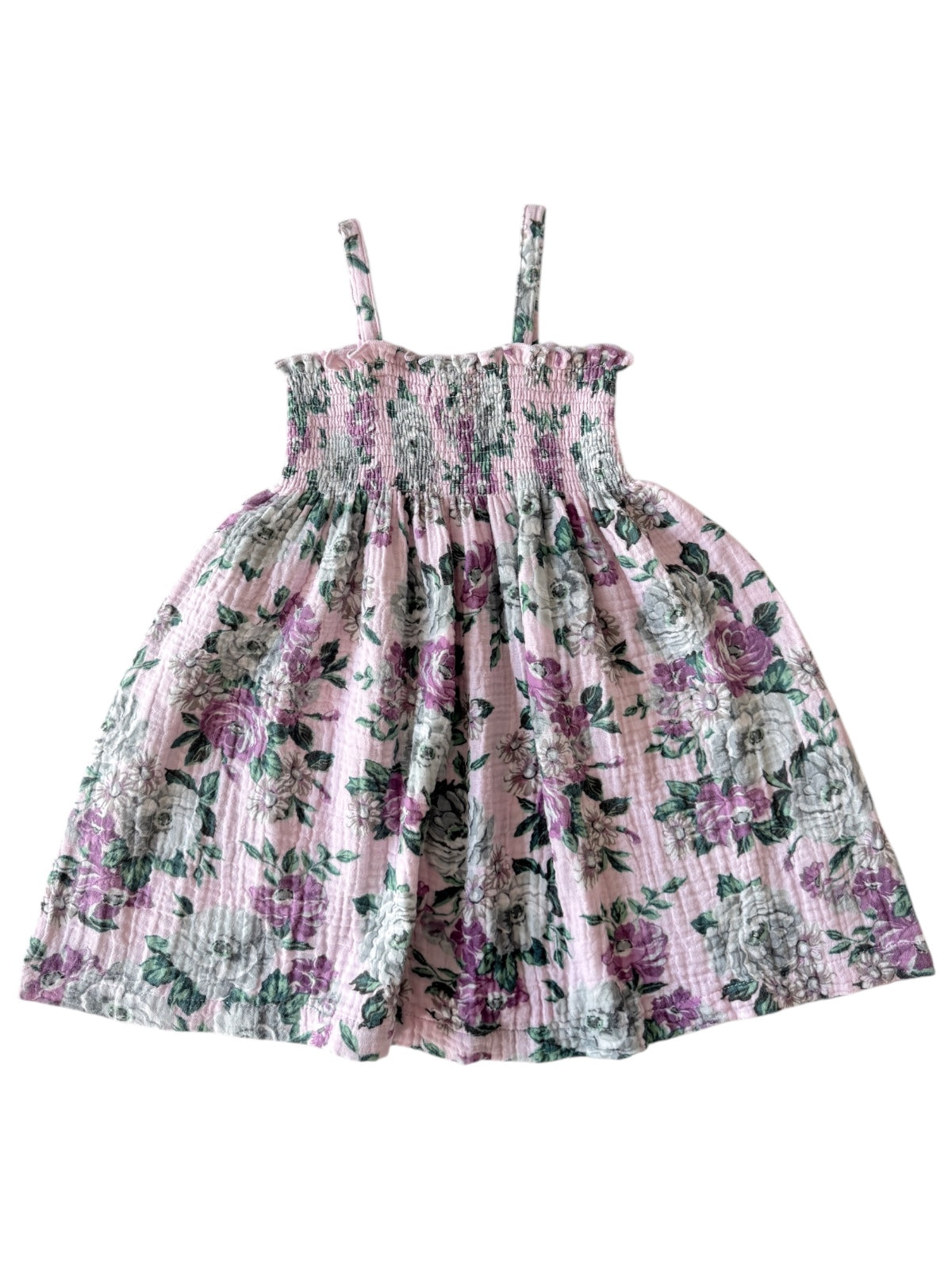 Floral pink dress with straps and smocked bodice, featuring green and purple rose patterns. Perfect for summer wear.
