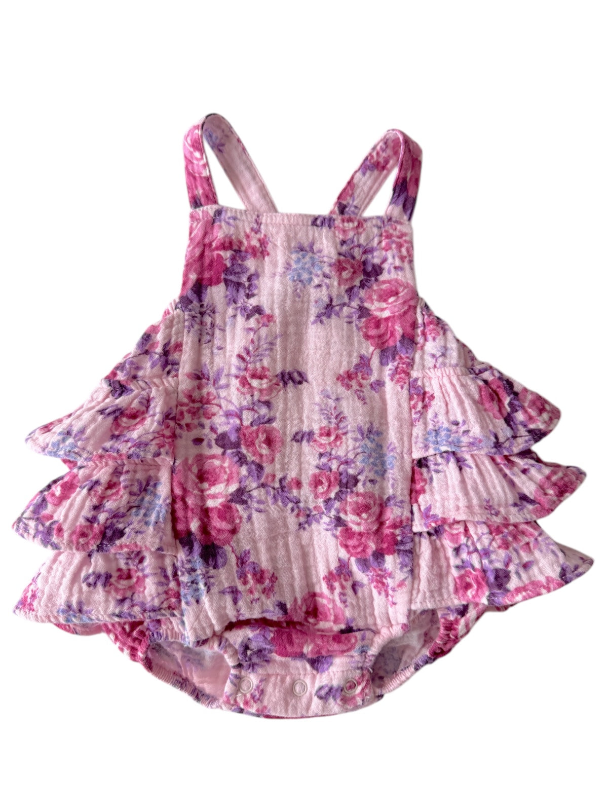 Floral infant romper with ruffled details in pink, purple, and white. Perfect for summer occasions.
