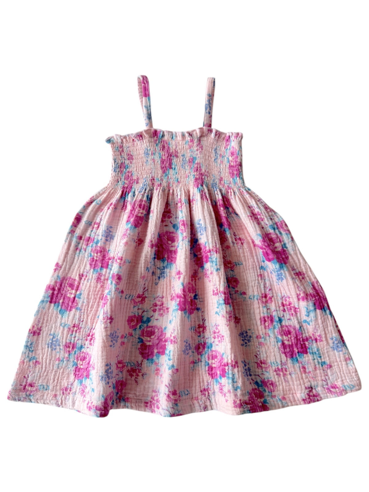 Pink floral dress with thin straps and a gathered skirt, featuring vibrant purple and blue flowers.