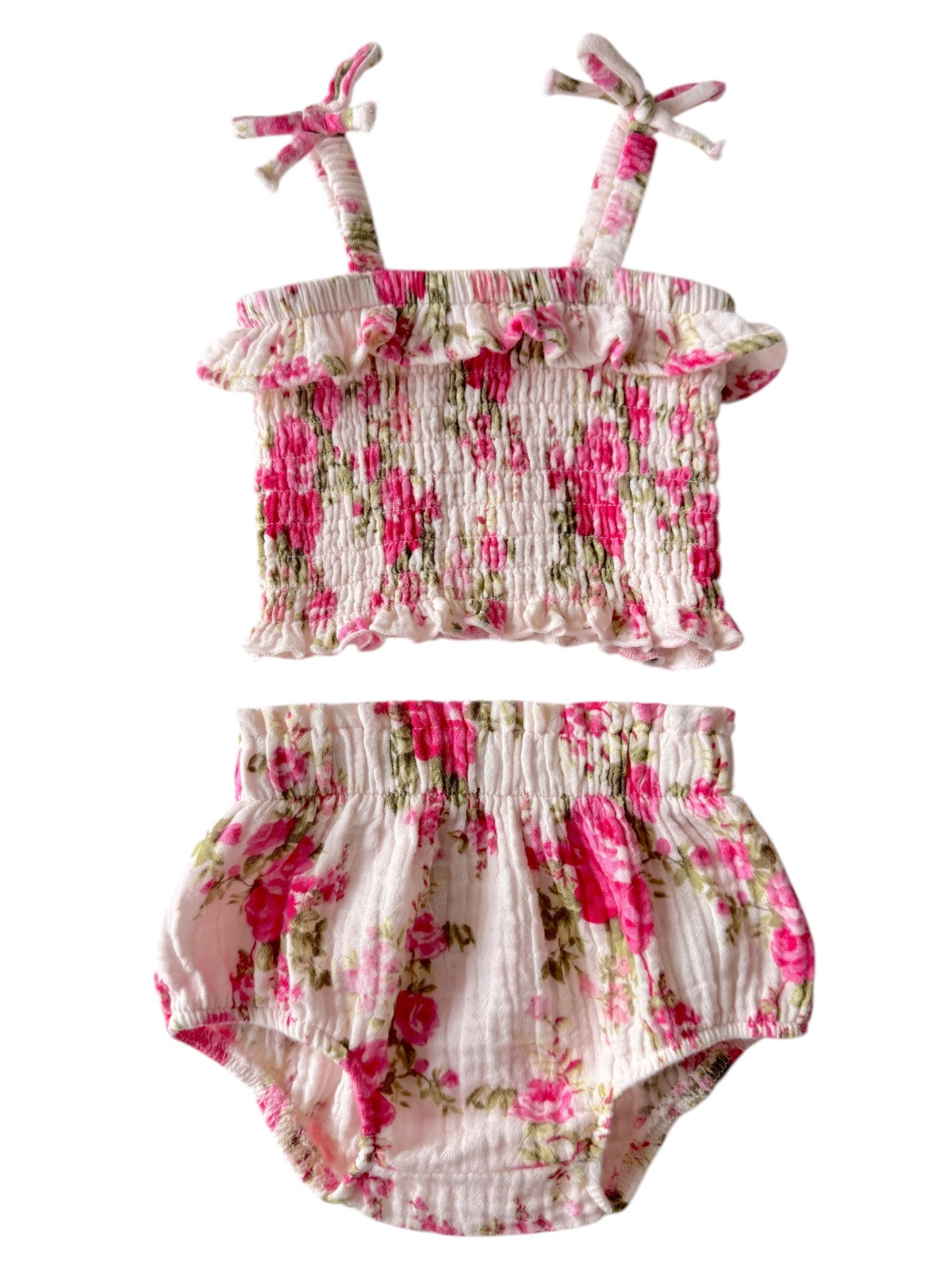 Floral baby outfit featuring a smocked top and matching bloomer shorts in pink and white.