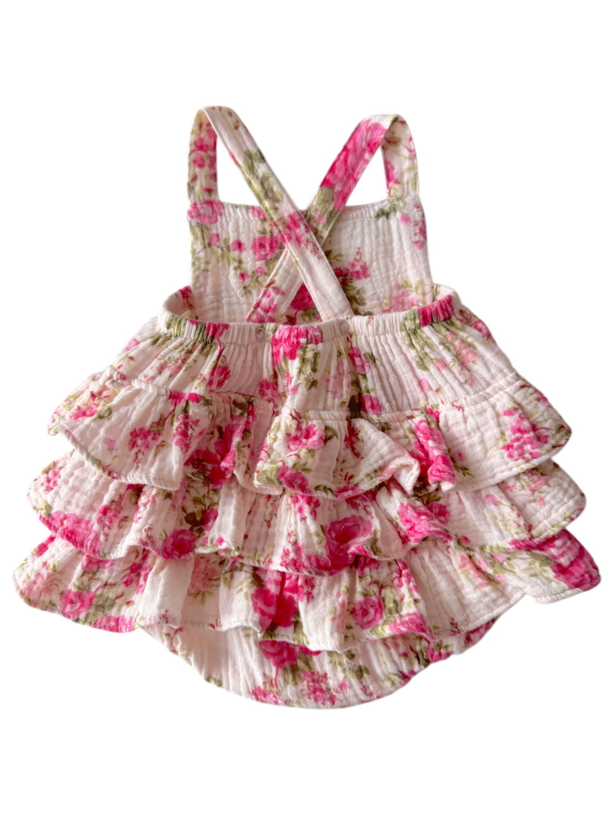 White floral dress with pink roses and ruffles, featuring crossed straps. Ideal for warm-weather outings.