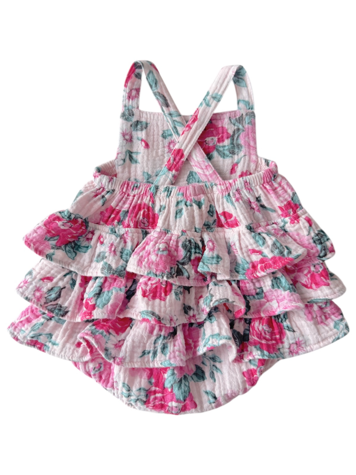 Floral girls' dress with layered ruffles in pink and green on a light background, featuring crossed back straps.