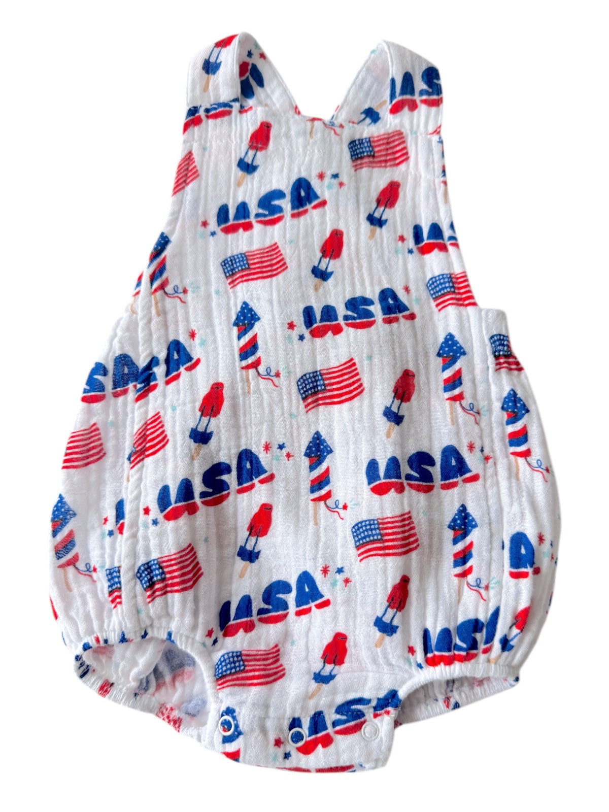White romper with red, blue, and white patterns of USA flags, popsicles, and stars. Ideal for patriotic occasions.