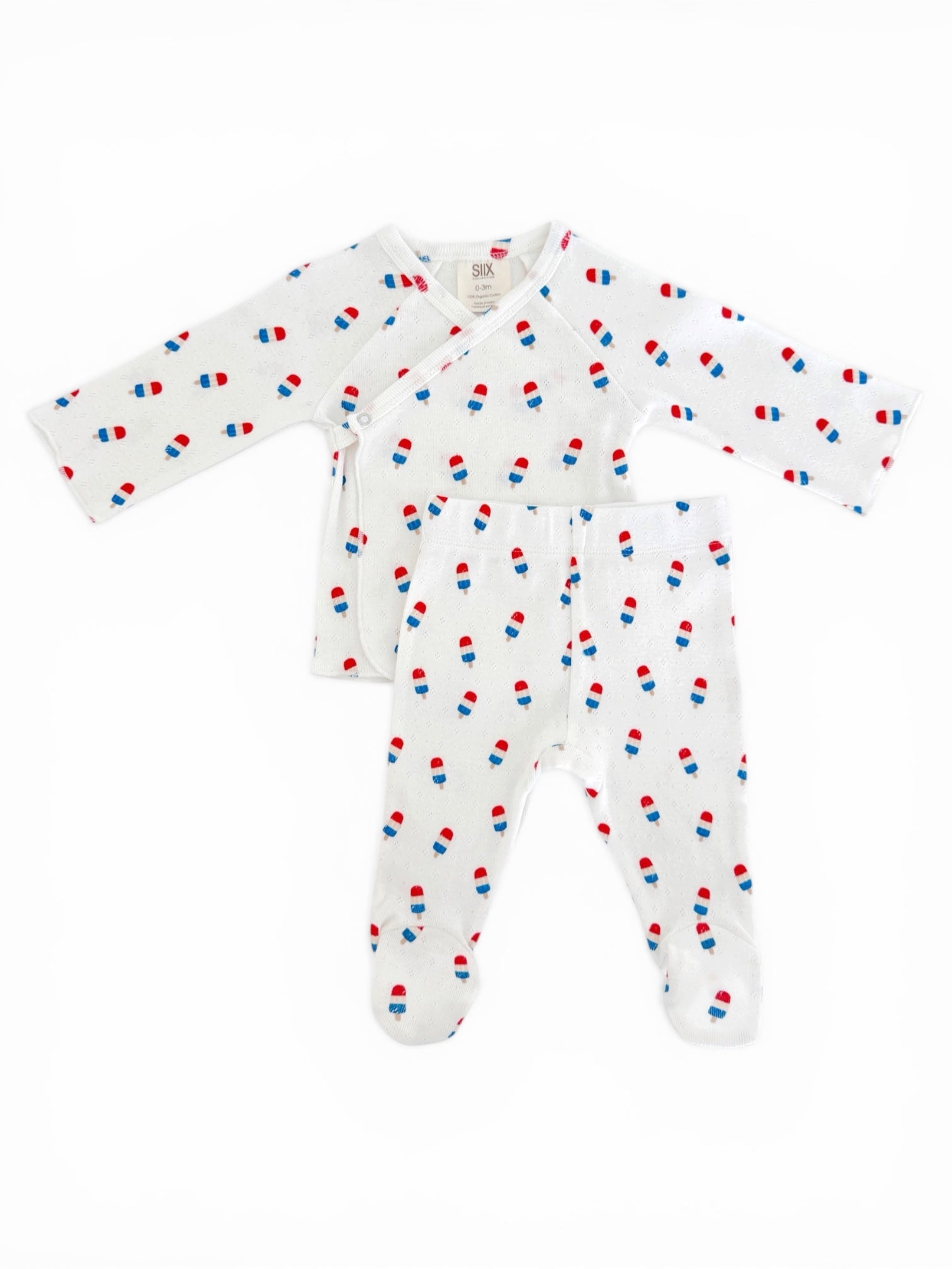 White baby outfit with long sleeves and pants, featuring red and blue popsicle prints.