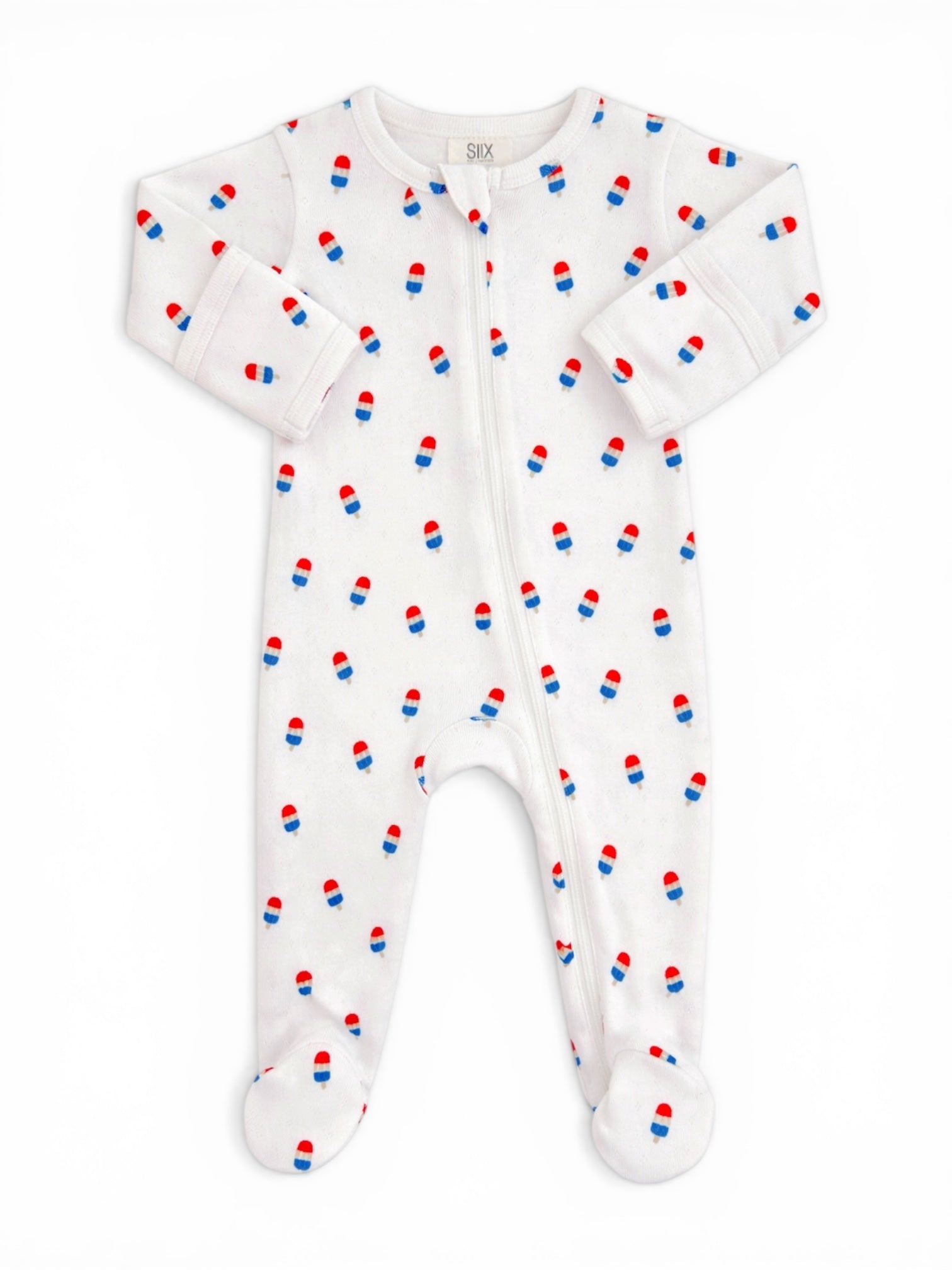 White baby onesie with red and blue pill print, featuring a front zipper and footed design.