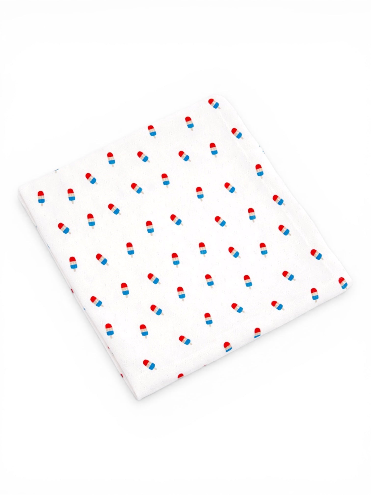 White fabric with a repeating pattern of blue and red ice cream cones.