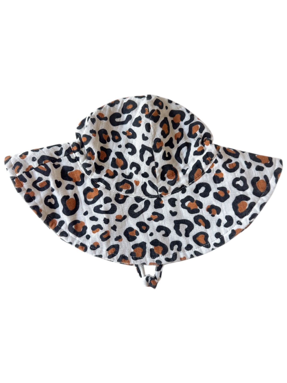 Leopard print sun hat with wide brim, featuring black and orange spots on a light background.