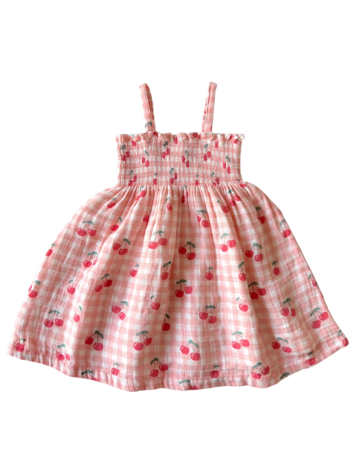 Pink dress with cherry print and smocked bodice, featuring thin straps and a flared skirt.