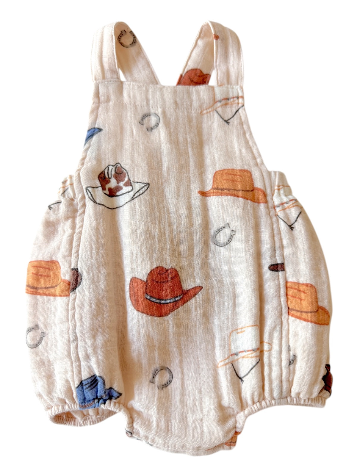 Cowboy-themed baby romper featuring hats and horseshoes in soft, breathable fabric. Ideal for playful adventures.