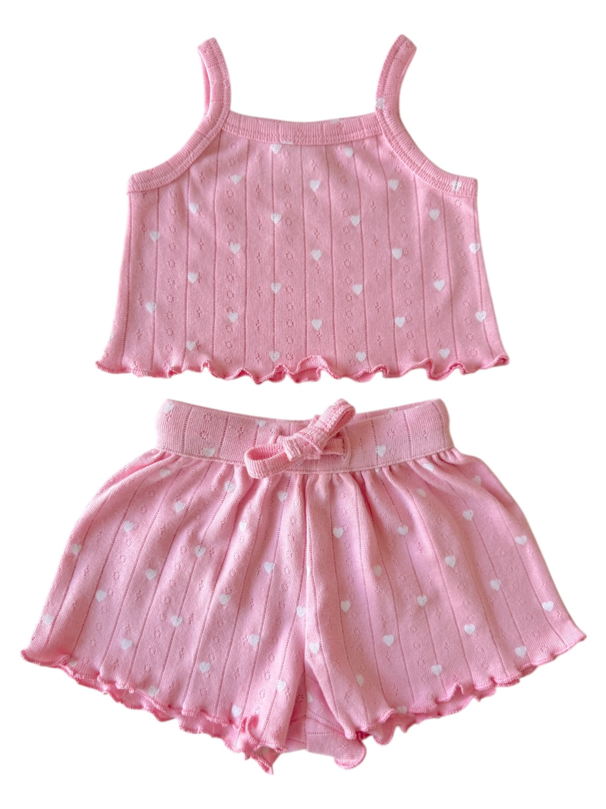 Pink heart-patterned tank top and shorts set for children, featuring a comfortable, playful design.