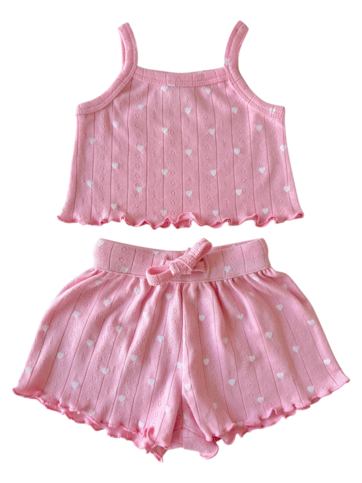 Pink heart-patterned tank top and shorts set for children, featuring a comfortable, playful design.