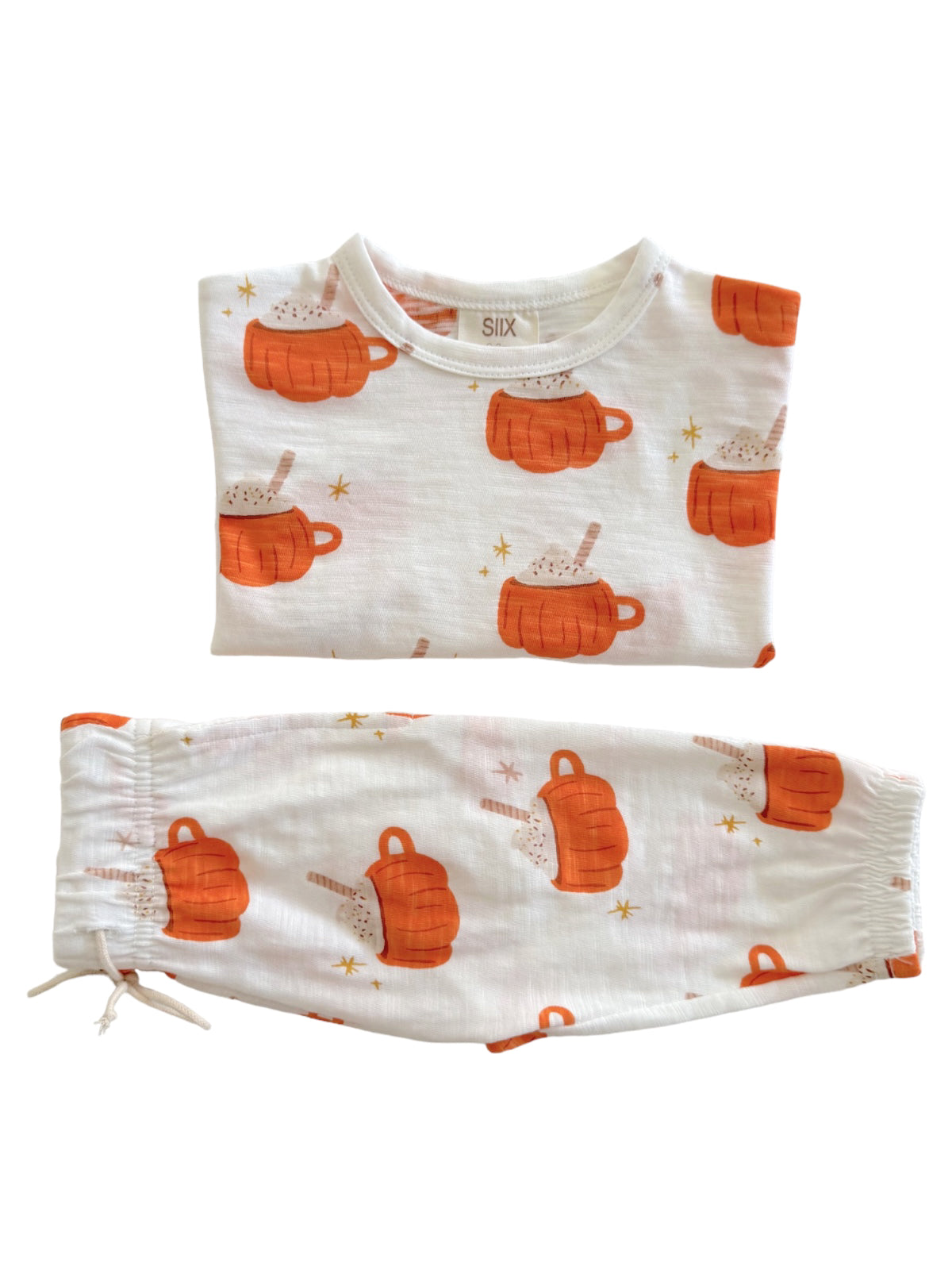 Two-piece pajama set featuring orange mugs and hot chocolate print on white fabric. Ideal for cozy nights.