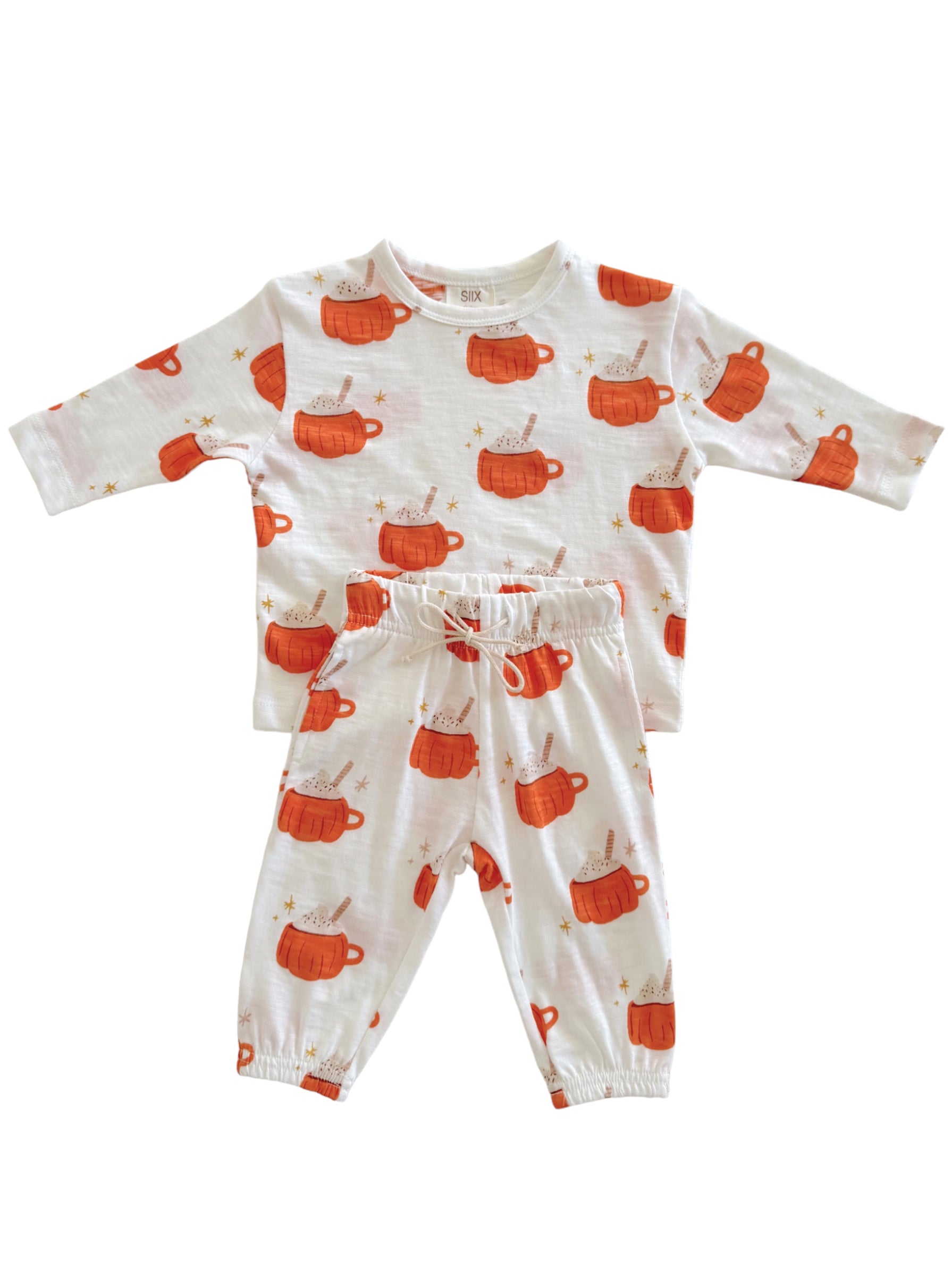 Children's pajama set featuring orange mugs with cream, stars, and a playful pattern on a white background.