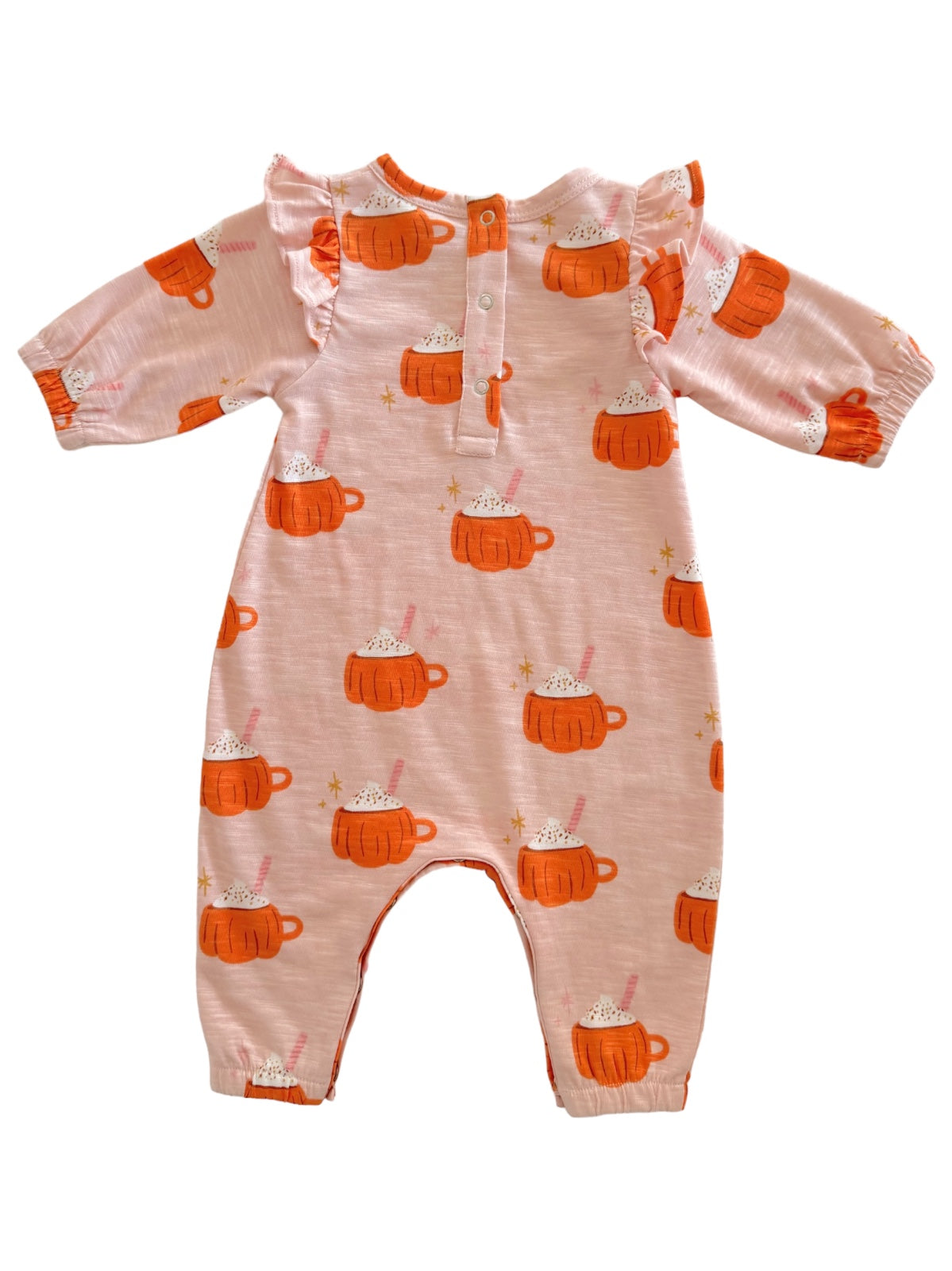 Pink onesie with orange mug designs and ruffles, featuring a cozy hot chocolate theme.
