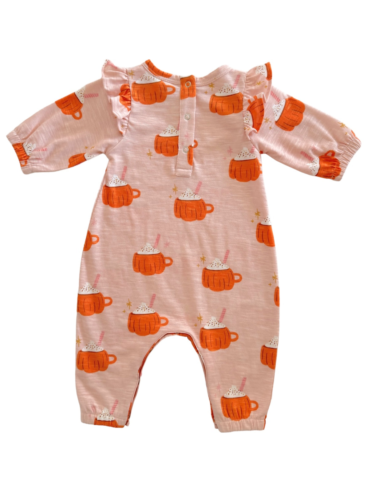 Pink onesie with orange mug designs and ruffles, featuring a cozy hot chocolate theme.