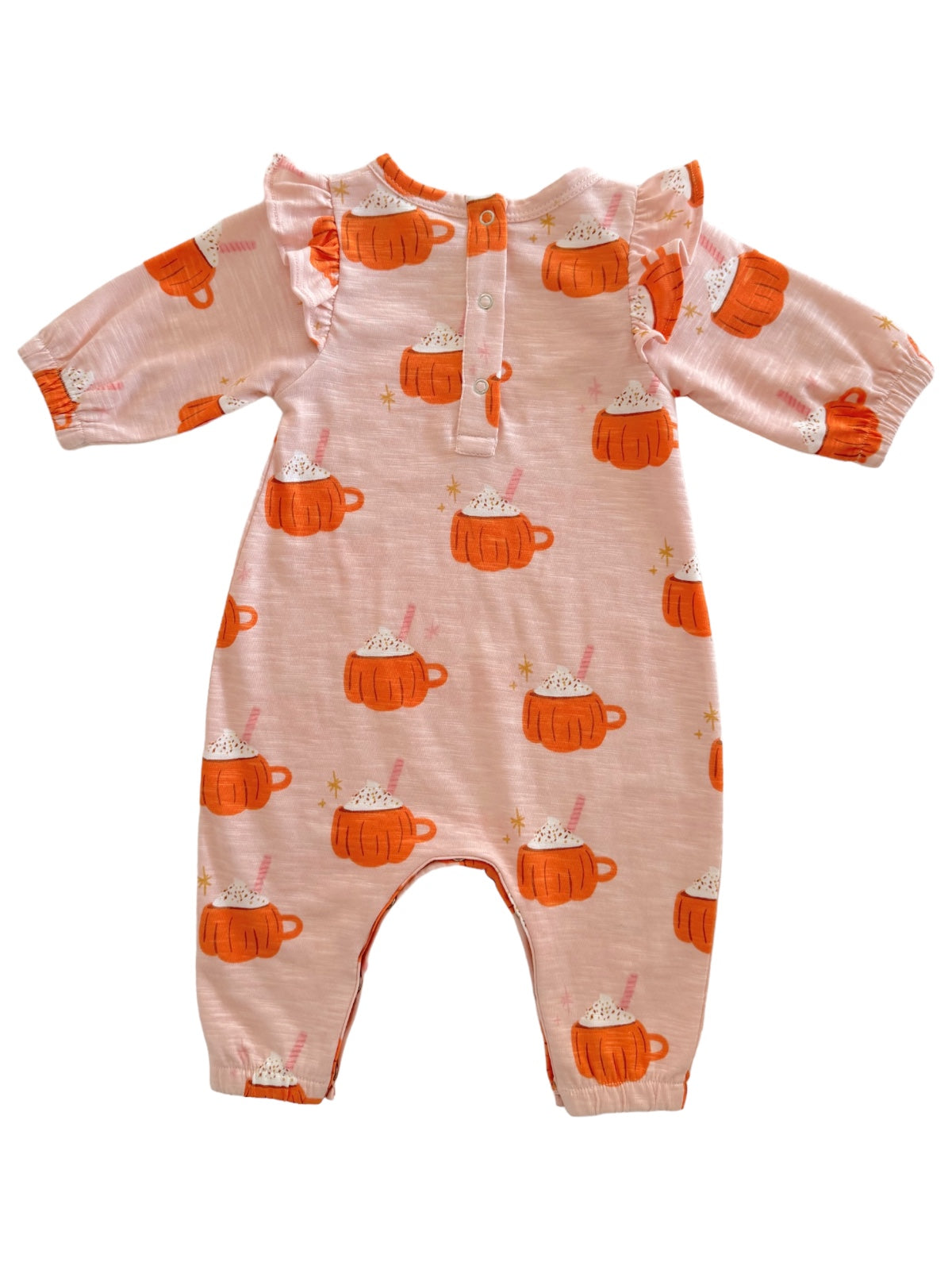 Pink onesie with orange mug designs and ruffles, featuring a cozy hot chocolate theme.