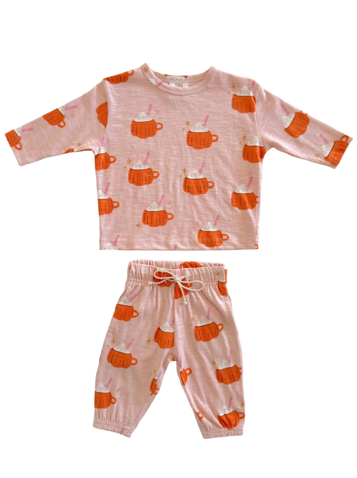 Pink pajama set featuring orange mugs with whipped cream and sprinkles pattern. Perfect for cozy, playful nights.