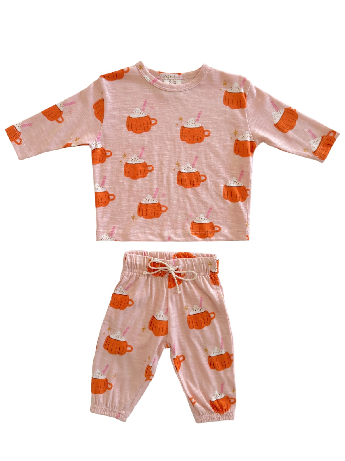 Pink pajama set featuring orange mugs with whipped cream and sprinkles pattern. Perfect for cozy, playful nights.