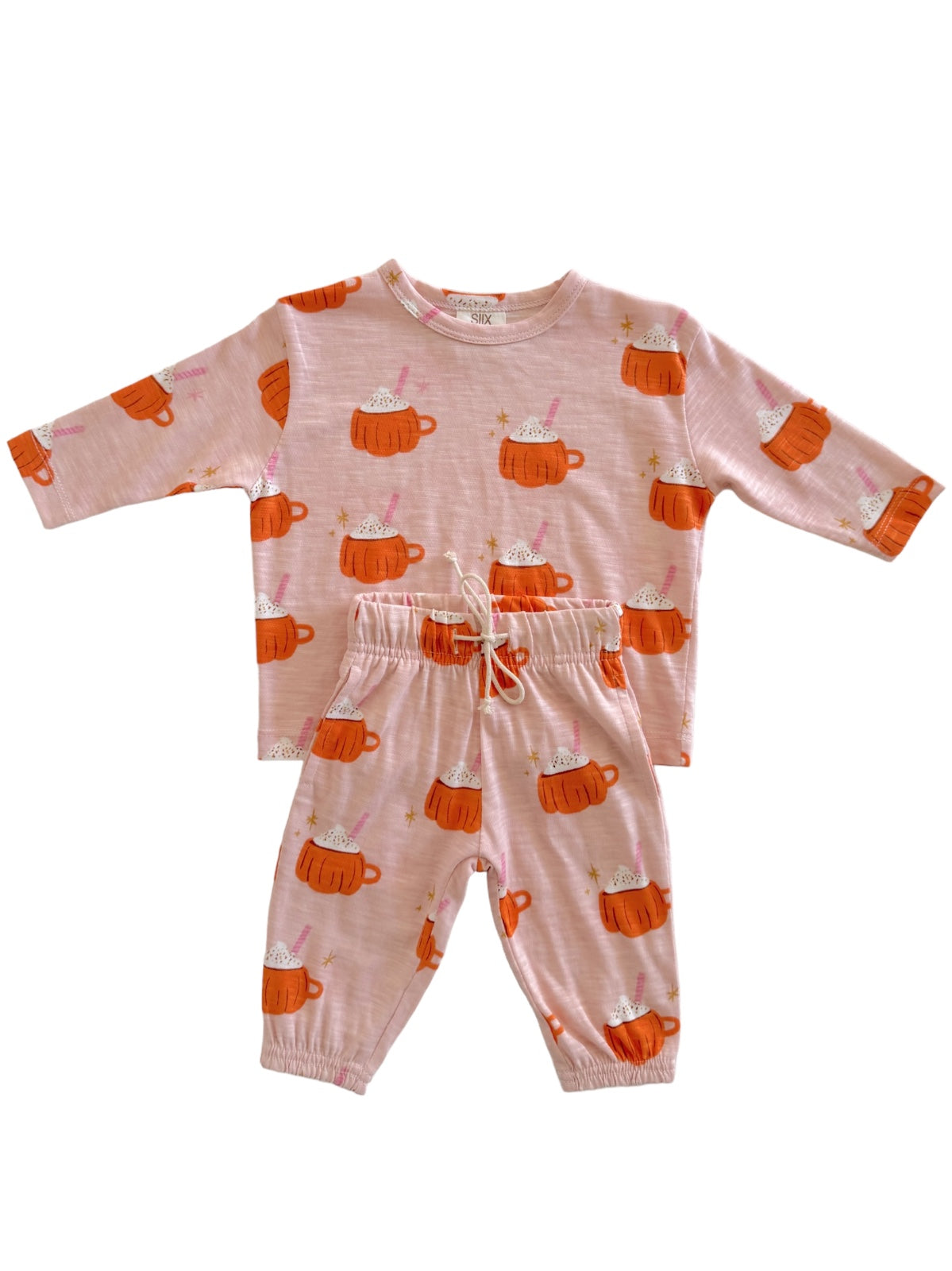 Kids' pajama set in pink with cute hot cup illustrations, featuring a long-sleeve top and elastic waist pants.