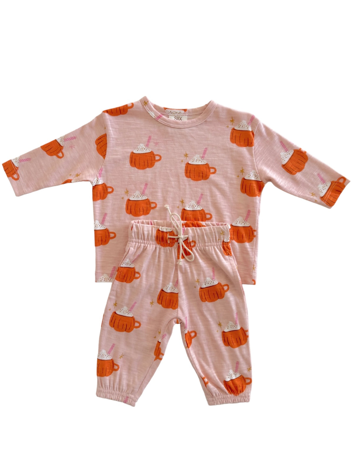 Kids' pajama set in pink with cute hot cup illustrations, featuring a long-sleeve top and elastic waist pants.