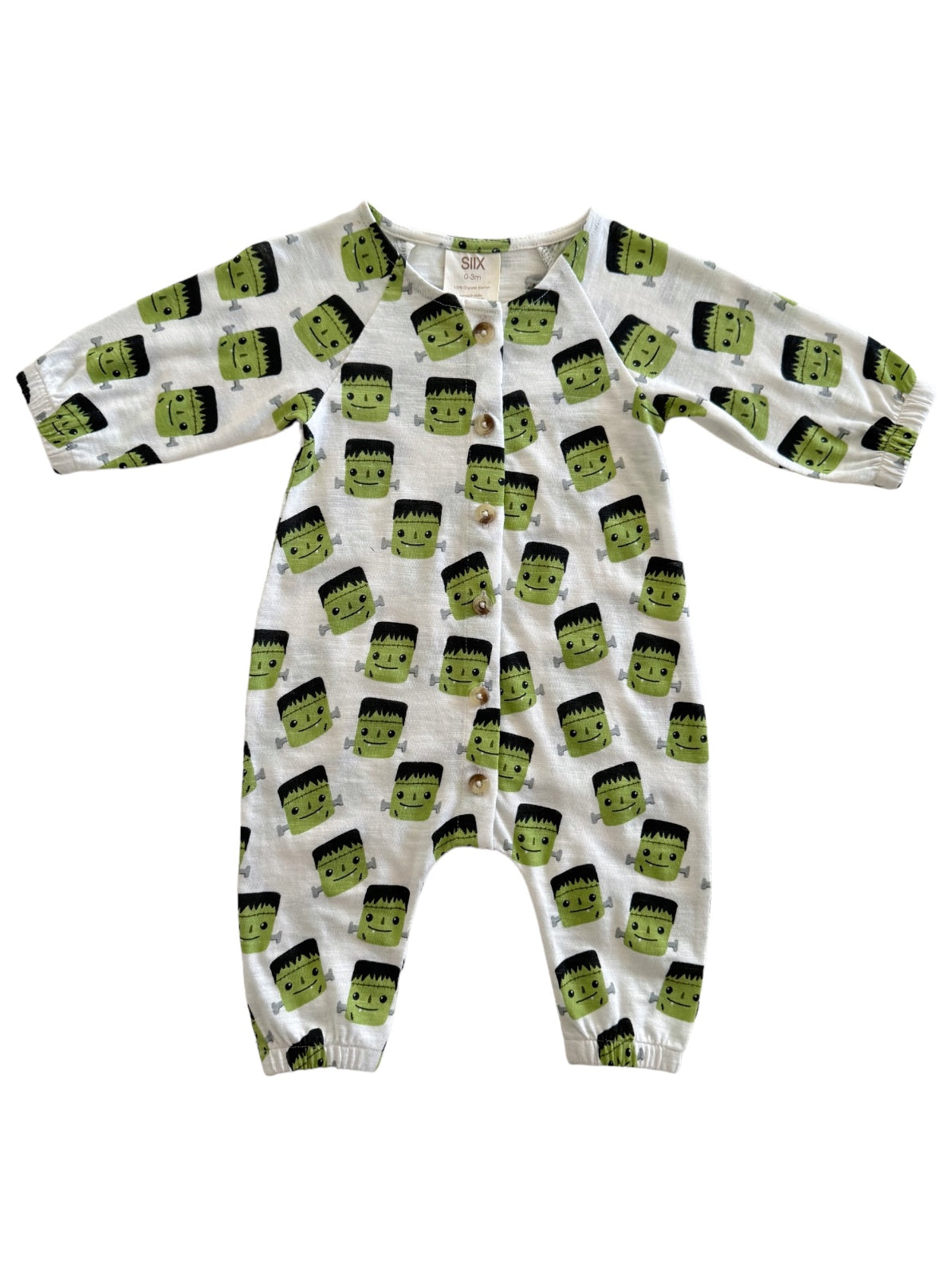 White baby onesie with green Frankenstein faces and black hair, featuring snap buttons down the front and elastic cuffs.