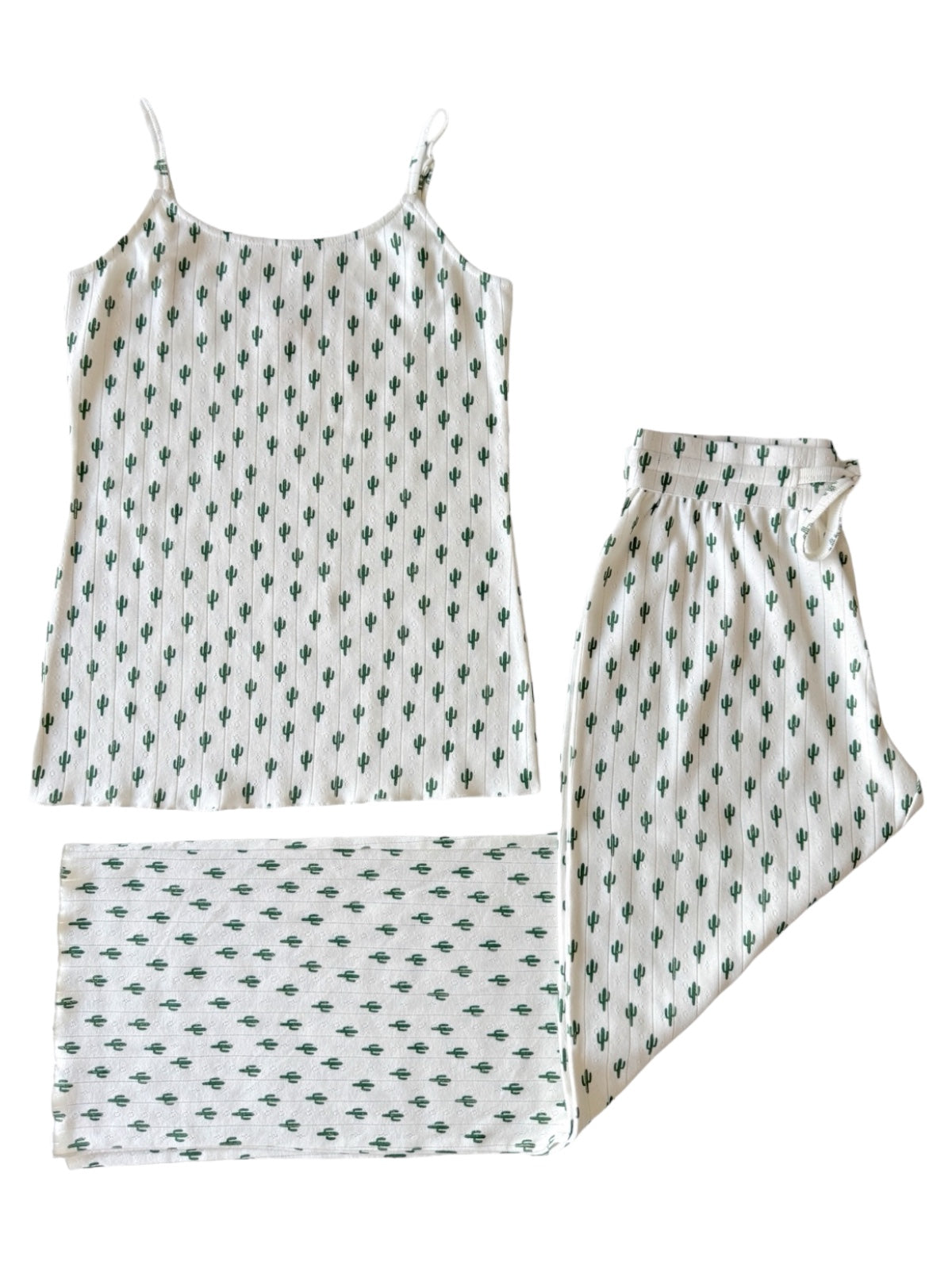 Cactus-patterned sleepwear set featuring a tank top, pants, and matching blanket in neutral colors.